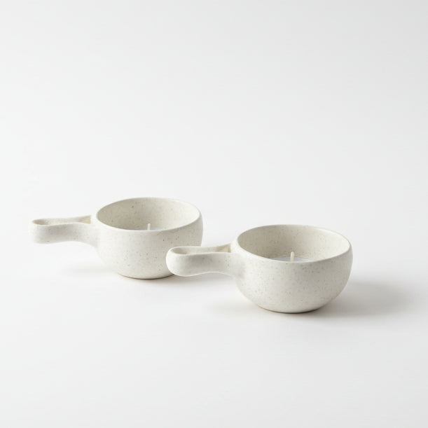 Second-hand white speckled ceramic ramekins as tealight holders