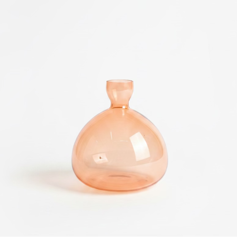 A small, rounded amber glass bottle with a short neck.